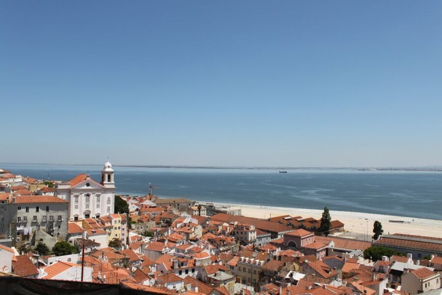 Lisbon: Alfama and São Jorge Castle Quarters Walking Tour - Taking in Lisbon from Portas do Sol