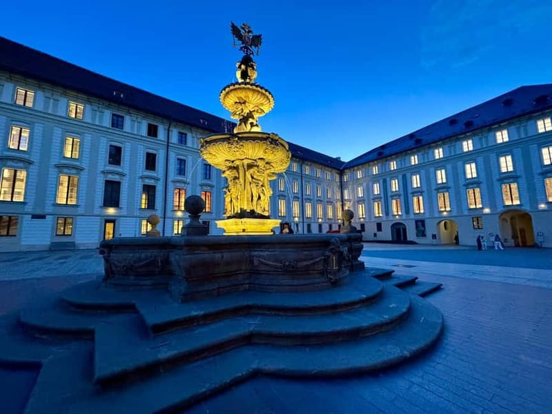 Prague: Night Walk through Prague Castle with City Views - Crossing the Deer Moat and entering the castle